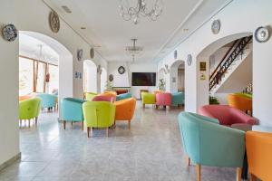 a waiting room with colorful chairs and tables at Hotel Ses Savines in San Antonio
