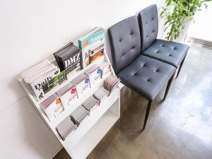 a black chair sitting next to a white desk at Starhostel Dongdaemun Suite in Seoul