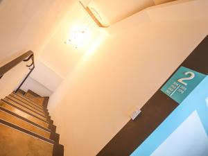 a hallway with stairs and a sign on the wall at Starhostel Dongdaemun Suite in Seoul