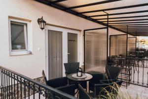 a balcony with a table and chairs on a patio at Apartmány Teddy Bojnice in Bojnice