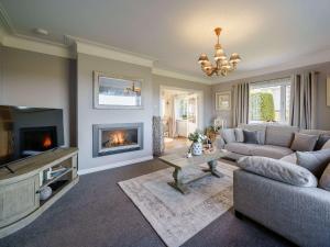 a living room with a couch and a fireplace at 3 Bed in Cockermouth 82438 in Dearham