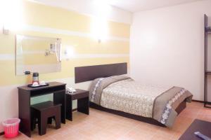 Postel nebo postele na pokoji v ubytování Metro Park Hotel Mandaue + 13 fotografií