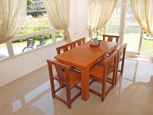 una sala da pranzo con tavolo e sedie in legno di Village Tree B&B a Ji'an