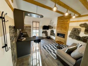 a kitchen and living room with a table and a couch at Armoni in Rota d'Imagna
