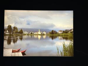 a view of a lake with two boats on it at Laax Flims Luxury Large apartment near Rock Resort in Laax-Murschetg