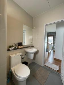 a white bathroom with a toilet and a sink at AnnaHome89/63@Latkrabang in Ban Khlong Prawet