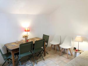 uma sala de jantar com uma mesa e cadeiras verdes em Voile et Plage, Villa 3 étoiles à La Trinité sur Mer em La Trinité-sur-Mer