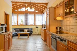 a kitchen and living room with a couch at Almerhof - Waldferienhof Almer in Zwiesel