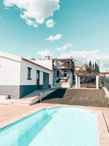 a house with a swimming pool in front of a house at Casa da Aldeia in Constância