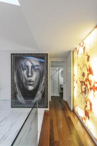 a living room with a painting on the wall at Golfe Villa ' Paraíso de Luxo ' Piscina Aquecida in Ponte de Lima