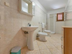 a bathroom with a sink and a toilet at Viola Three in Novigrad Istria