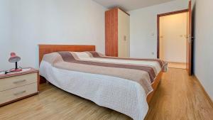 a bedroom with a large bed and a night stand at Viola Three in Novigrad Istria