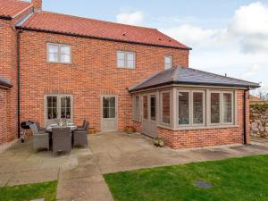 an extension to a brick house with a conservatory at 3 Bed in Burnham Deepdale KT045 in Burnham Deepdale