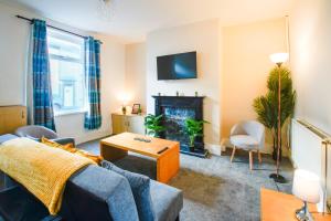 a living room with a couch and a fireplace at Comfy House for Contractors, Families, Accrington in Accrington