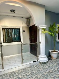 an entrance to a building with a potted plant at The Retreat Apartments in Brusubi