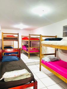 a room with four bunk beds in a room at adriana hostel in Itacaré