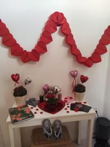 a table with a heart shaped mirror on a wall at Ta' Stef's Holiday Suites in San Lawrenz