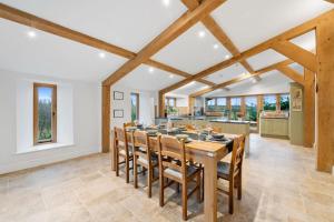 a dining room with a wooden table and chairs at Knoll View Ranch - Group Hot Tub in Shepton Mallet