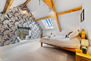a bedroom with a large bed in a attic at Knoll View Ranch - Group Hot Tub in Shepton Mallet