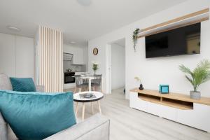 a living room with a couch and a table at Elegant Apartment in the centre of Gdynia by Renters in Gdynia