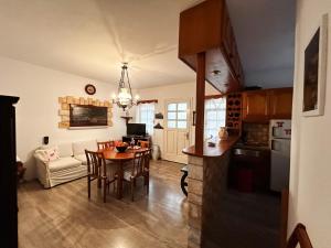 a kitchen and living room with a table and chairs at Dryades House in Kinidaros in Naxos Chora