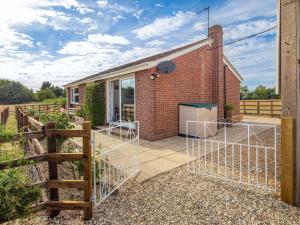 a brick house with a gate in front of it at 3 Bed in Thame 88963 in Shabbington