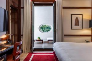 a hotel room with a bed and a window at Portrait Milano - Lungarno Collection in Milan