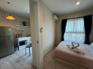 a bedroom with a bed with a swan decoration on it at Plum Central Near shopping Mall @ Bangyai in Nonthaburi