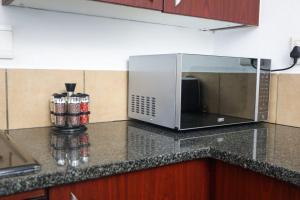 a microwave oven sitting on a counter in a kitchen at Spacious and luxury 3 bedroom apartment in Midrand +7 photos