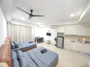 a living room with a couch and a kitchen at Wan's Homestay i-City in Shah Alam