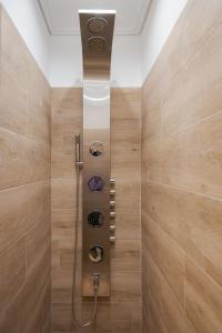 a shower in a bathroom with wooden walls at Glyfada Cozy Living in Athens