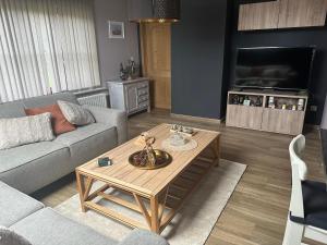 a living room with a couch and a coffee table at 't Coureurke in Brakel