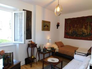 a living room with a bed and a window at Cottage in Auvergne near Puy Mary in LʼHôpital +32 photos
