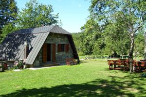 a small cabin with a roof on a grass field at Holiday House Casini di Corte in Corfino