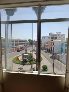 a window with a view of a city street at Departamentos Cristo Rey 3 in Tacna