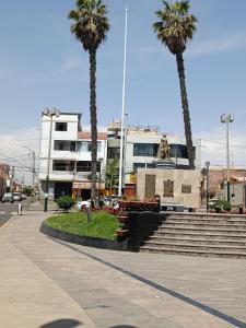 a group of palm trees in front of a building at Departamentos Cristo Rey 3 in Tacna