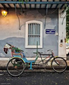 a bike parked in front of a building at Serenity Sands Beach Resort in Puducherry