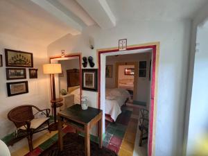 a bedroom with a bed and a table and a mirror at AlCOVA REALE Apartment and organic honey Cisternino cda specchia 33 in Cisternino