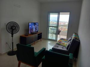 Телевизор и/или развлекательный центр в Apartamento Frente Mar