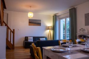 a living room with a table and a couch at Ti Gwenn in Crozon