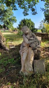 a statue of a woman sitting on a rock at Château MontPlaisir charming b&b in Provence in Valréas