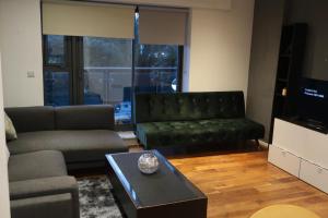 uma sala de estar com um sofá e uma mesa de centro em Immaculate 1-Bed Apartment in London em Londres