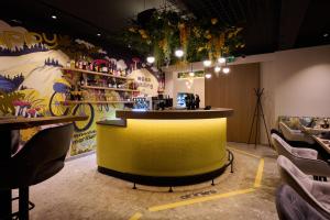 a bar in a restaurant with a yellow at happYellow Boutique House in Saalbach Hinterglemm