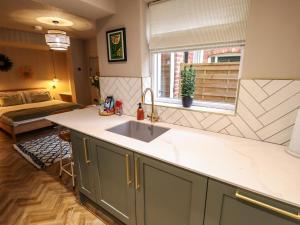 a kitchen with a sink and a bed in a room at 17 Union Road Basement in Lincoln