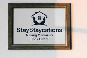 a picture of a sign in a frame on a wall at Collingwood House by StayStaycations in Bristol