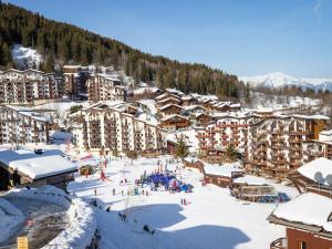 a ski resort in the snow with people on the slopes at Appartement La Tania, 2 pièces, 4 personnes - FR-1-182A-5 in Courchevel