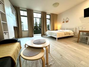 a bedroom with a bed and a table in a room at Apartamenty Marea Rentals Bulwar Portowy Ustka in Ustka