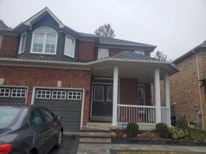 a house with a car parked in front of it at Cozy & Convenient Studio Apartment in Pickering