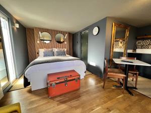 a bedroom with a bed with a red suitcase at Rockmount Rooms & Apartment in Tavistock