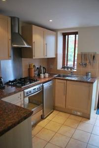 a kitchen with a stove and a sink at Barn conversion near the coast in Paignton